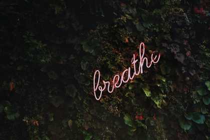A neon sign saying breathe
